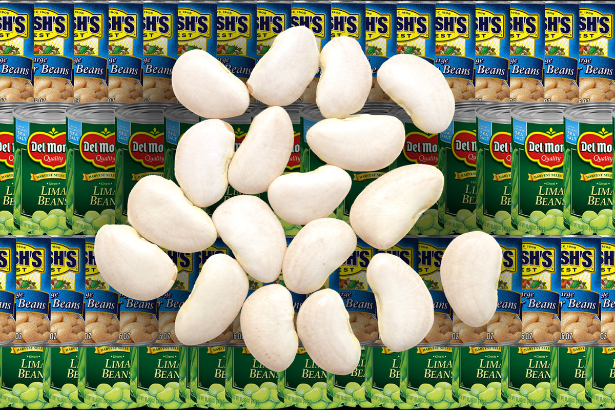 Dry butter beans spread on top of a backdrop of canned butter beans.