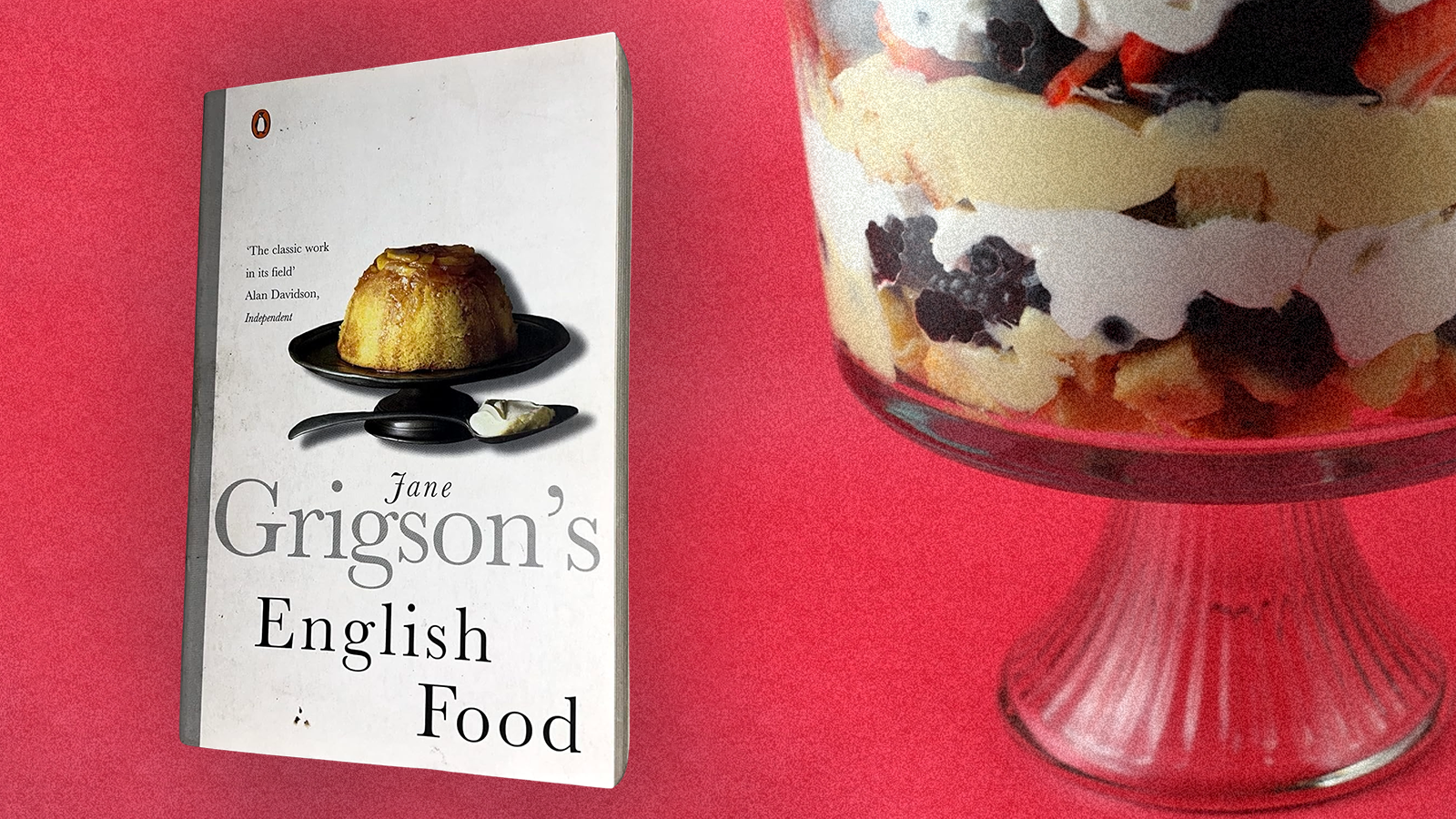 The cover of Jane Grigson’s English Food next to a layered trifle in a glass serving dish. Photo illustration.
